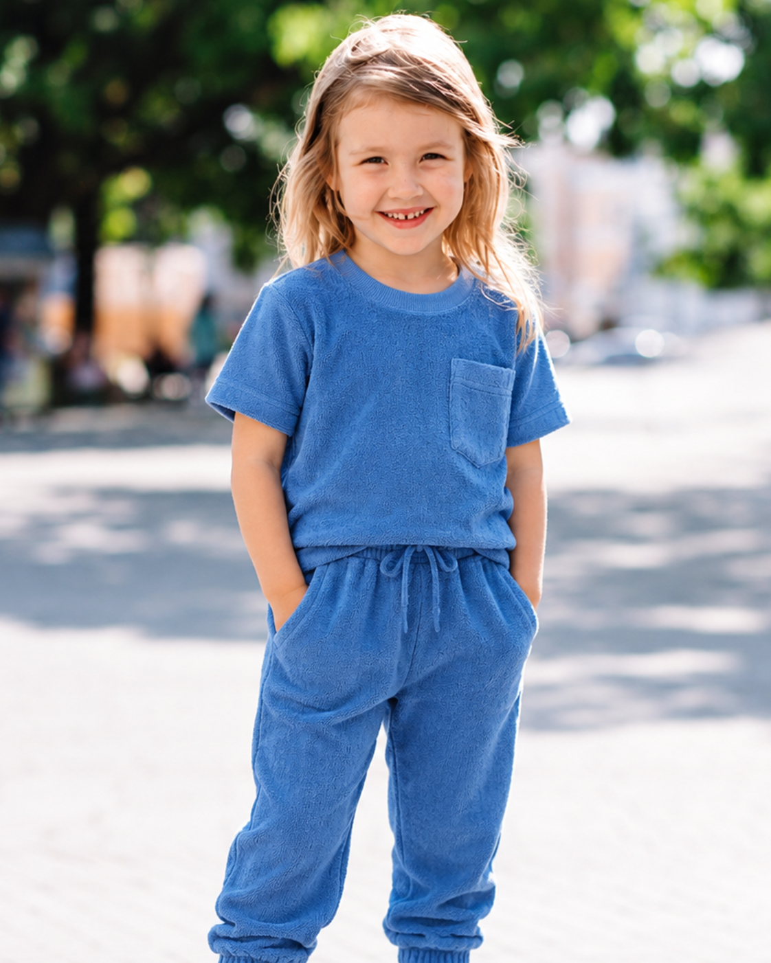 A child in a Cove Kids button-down at an outdoor table